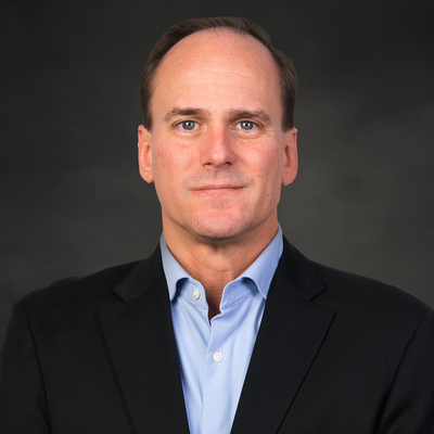 man in dark suit with light blue button down shirt